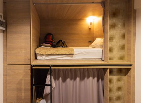 Interior view of capsule bedroom in hostel. Capsule bedroom, bed in box or pod. Small simple bedroom interior design with modern and luxury style in Bangkok Thailand.の写真素材