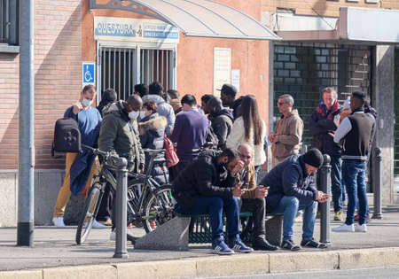 Italy, Como, March, migrants lined up in front of the police office to receive a residence permit or asylumのeditorial素材