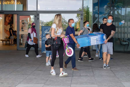Italy, Milan, 05/31/2020, people walk wearing surgical mask due to the social distance for coronavirus covidのeditorial素材