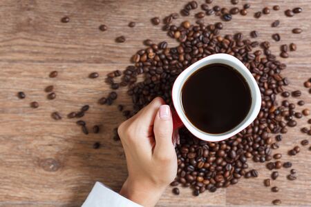 Woman holding a cup of hot coffeeの写真素材