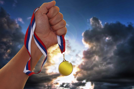 The sportsman holding a gold medalの写真素材