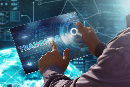 Internet. Business. Technology concept.
Businessman presses a button Trainings on the virtual screen tablet future date.の写真素材