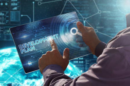 Internet. Business. Technology concept.Businessman presses a button Development Plan on the virtual screen tablet future date.の写真素材