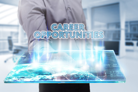 Business, Technology, Internet and network concept. Young businessman working on a tablet of the future, he sees the inscription: career opportunitiesの写真素材