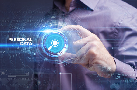 Business, Technology, Internet and network concept. Young businessman working on a virtual screen of the future and sees the inscription: personal dataの写真素材