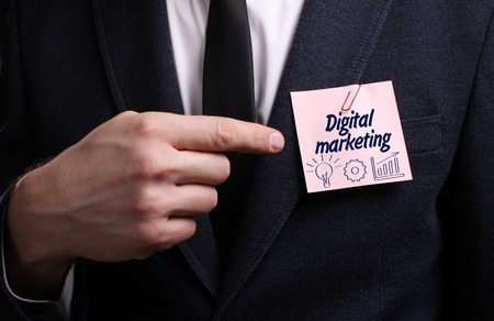 Business, Technology, Internet and network concept. Young businessman shows the word: Digital marketingの写真素材