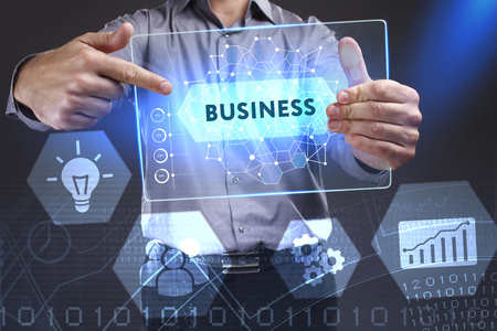 Business, Technology, Internet and network concept. Young businessman showing a word in a virtual tablet of the future: Businessの写真素材