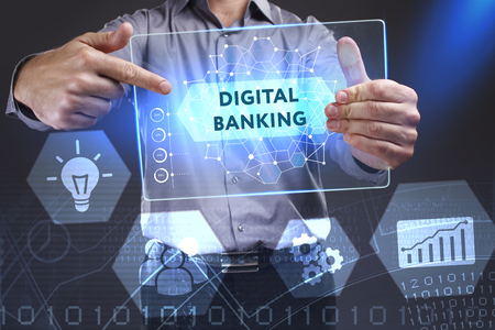 Business, Technology, Internet and network concept. Young businessman showing a word in a virtual tablet of the future: Digital bankingの写真素材
