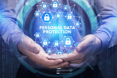Business, Technology, Internet and network concept. Young businessman shows the word on the virtual display of the future: Personal data protectionの写真素材