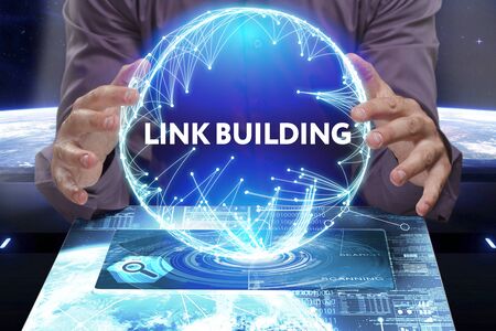 Business, Technology, Internet and network concept. Young businessman shows the word on the virtual display of the future: Link buildingの写真素材