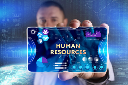 Business, Technology, Internet and network concept. Young businessman showing a word in a virtual tablet of the future: Human resourcesの写真素材