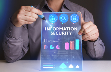 Business, Technology, Internet and network concept. Young businessman working on a virtual screen of the future and sees the inscription: Information securityの写真素材