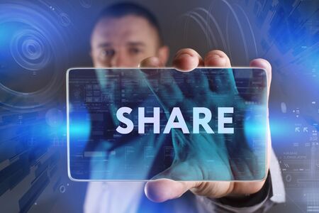 Business, Technology, Internet and network concept. Young businessman working on a virtual screen of the future and sees the inscription: Shareの写真素材
