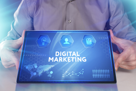 Business, Technology, Internet and network concept. Young businessman working on a virtual screen of the future and sees the inscription: Digital Marketingの写真素材