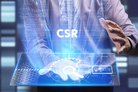 Business, Technology, Internet and network concept. Young businessman working on a virtual screen of the future and sees the inscription: CSRの写真素材