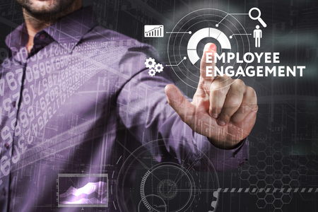 Business, Technology, Internet and network concept. Young businessman working on a virtual screen of the future and sees the inscription: Employee engagementの写真素材