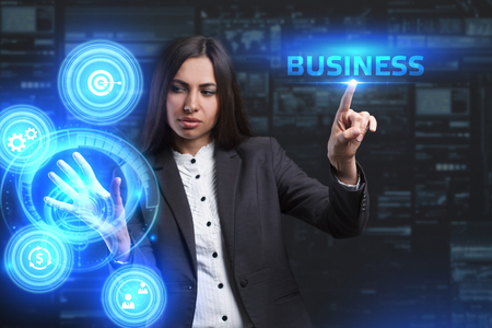 The concept of business, technology, the Internet and the network. A young entrepreneur working on a virtual screen of the future and sees the inscription: Businessの写真素材