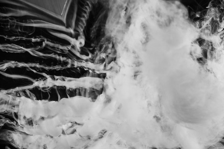 Movement of white smoke.black background. Smoke from cigarettes. Vapeの写真素材