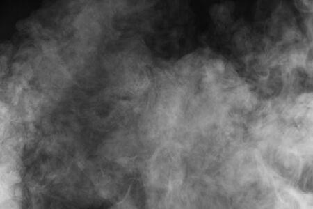 Movement of white smoke.black background. Smoke from cigarettes. Vapeの写真素材