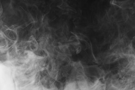 Movement of white smoke.black background. Smoke from cigarettes. Vapeの写真素材