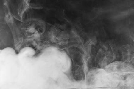 Movement of white smoke.black background. Smoke from cigarettes. Vapeの写真素材