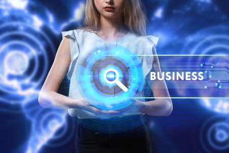 The concept of business, technology, the Internet and the network. A young entrepreneur working on a virtual screen of the future and sees the inscription: Businessの写真素材