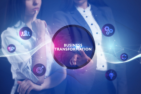 The concept of business, technology, the Internet and the network. A team of business women working on the virtual screen of the future and see the inscription: Business transformationの写真素材