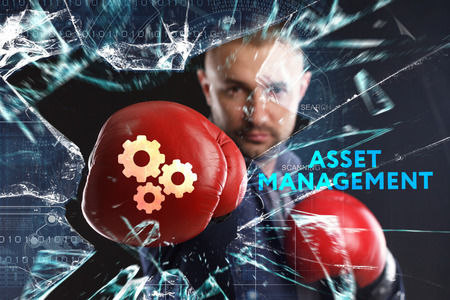 The concept of business, technology, the Internet and the network. A young businessman overcomes difficulties and sees an inscription: Asset managementの写真素材