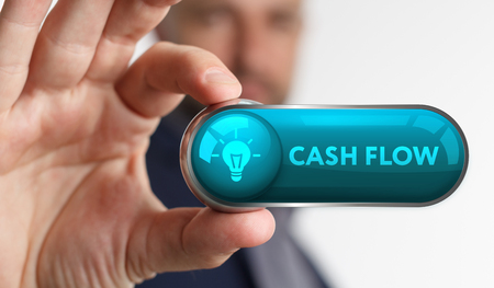 The concept of business, technology, the Internet and the network. A young entrepreneur working on a virtual screen of the future and sees the inscription: Cash flowの写真素材