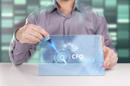 The concept of business, technology, the Internet and the network. A young entrepreneur working on a virtual screen of the future and sees the inscription: CFOの写真素材