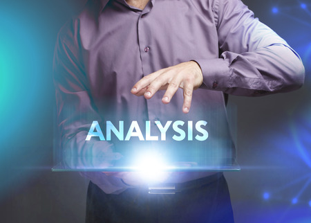 The concept of business, technology, the Internet and the network. A young entrepreneur working on a virtual screen of the future and sees the inscription: Analysis The concept of business, technology, the Internet and the network. A young entrepreneur working on a virtual screen of the future and sees the inscription: Analysis