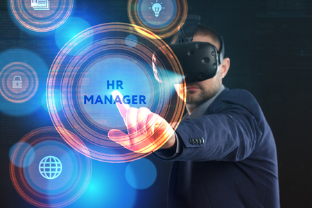 Business, Technology, Internet and network concept. Young businessman working in virtual reality glasses sees the inscription: HR managerの写真素材