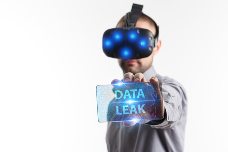 Business, Technology, Internet and network concept. Young businessman working in virtual reality glasses sees the inscription: Data leakの写真素材