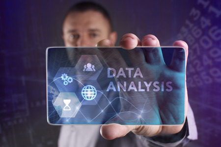 The concept of business, technology, the Internet and the network. A young entrepreneur working on a virtual screen of the future and sees the inscription: Data analysisの写真素材
