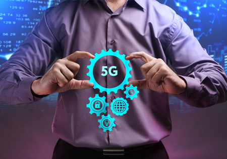 The concept of business, technology, the Internet and the network. A young entrepreneur working on a virtual screen of the future and sees the inscription: 5Gの写真素材