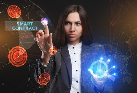 The concept of business, technology, the Internet and the network. A young entrepreneur working on a virtual screen of the future and sees the inscription: smart contractの写真素材