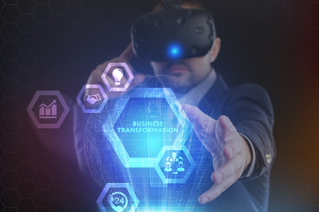 The concept of business, technology, the Internet and the network. A young entrepreneur working on a virtual screen of the future and sees the inscription: Business transformationの写真素材