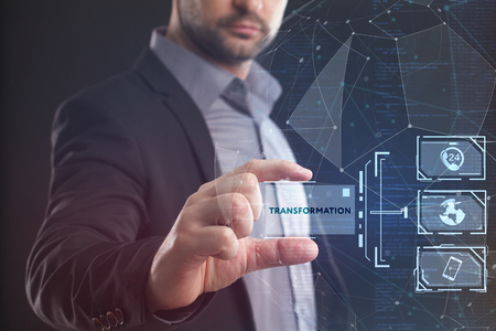 The concept of business, technology, the Internet and the network. A young entrepreneur working on a virtual screen of the future and sees the inscription: Transformationの写真素材