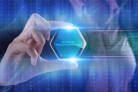 The concept of business, technology, the Internet and the network. A young entrepreneur working on a virtual screen of the future and sees the inscription: Business transformationの写真素材