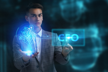 The concept of business, technology, the Internet and the network. A young entrepreneur working on a virtual screen of the future and sees the inscription: CFOの写真素材