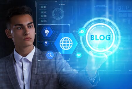 The concept of business, technology, the Internet and the network. A young entrepreneur working on a virtual screen of the future and sees the inscription: Blogの写真素材