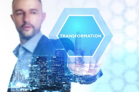 The concept of business, technology, the Internet and the network. A young entrepreneur working on a virtual screen of the future and sees the inscription: Transformationの写真素材