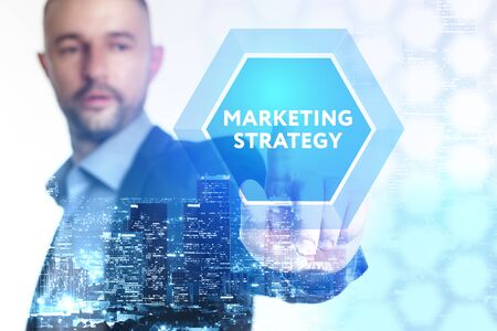 The concept of business, technology, the Internet and the network. A young entrepreneur working on a virtual screen of the future and sees the inscription: marketing strategyの写真素材