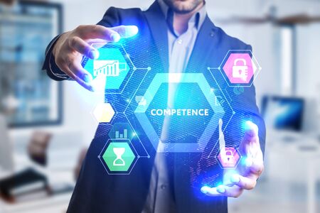 The concept of business, technology, the Internet and the network. A young entrepreneur working on a virtual screen of the future and sees the inscription: Competenceの写真素材