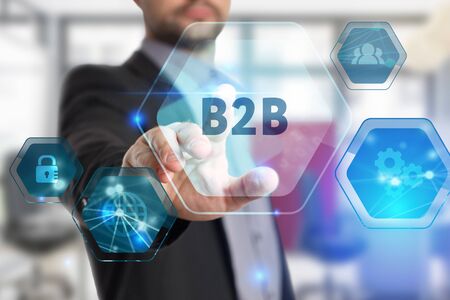 The concept of business, technology, the Internet and the network. A young entrepreneur working on a virtual screen of the future and sees the inscription: B2Bの写真素材
