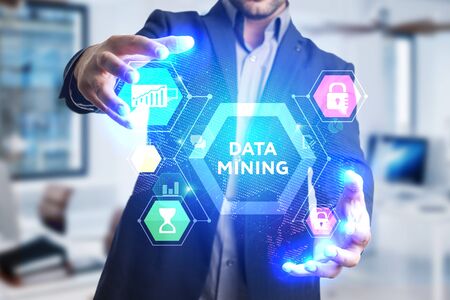 The concept of business, technology, the Internet and the network. A young entrepreneur working on a virtual screen of the future and sees the inscription: Data miningの写真素材