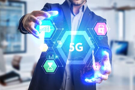 The concept of business, technology, the Internet and the network. A young entrepreneur working on a virtual screen of the future and sees the inscription: 5Gの写真素材