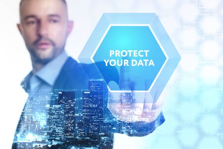 The concept of business, technology, the Internet and the network. A young entrepreneur working on a virtual screen of the future and sees the inscription: Protect your dataの写真素材