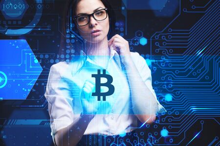 The concept of business, technology, the Internet and the network. A young entrepreneur working on a virtual screen of the future and sees the inscription: bitcoinの写真素材