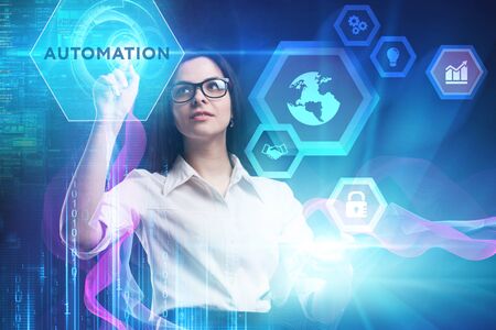 The concept of business, technology, the Internet and the network. A young entrepreneur working on a virtual screen of the future and sees the inscription: Automationの写真素材